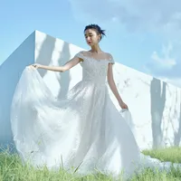 繊細で精巧で 圧倒的な美しさを放つ ホワイトビーディングが最大の魅力。 ショルダーやスカートの裾にかけて ビーディングがグラデーションになっていく様は 圧巻の美しさ。