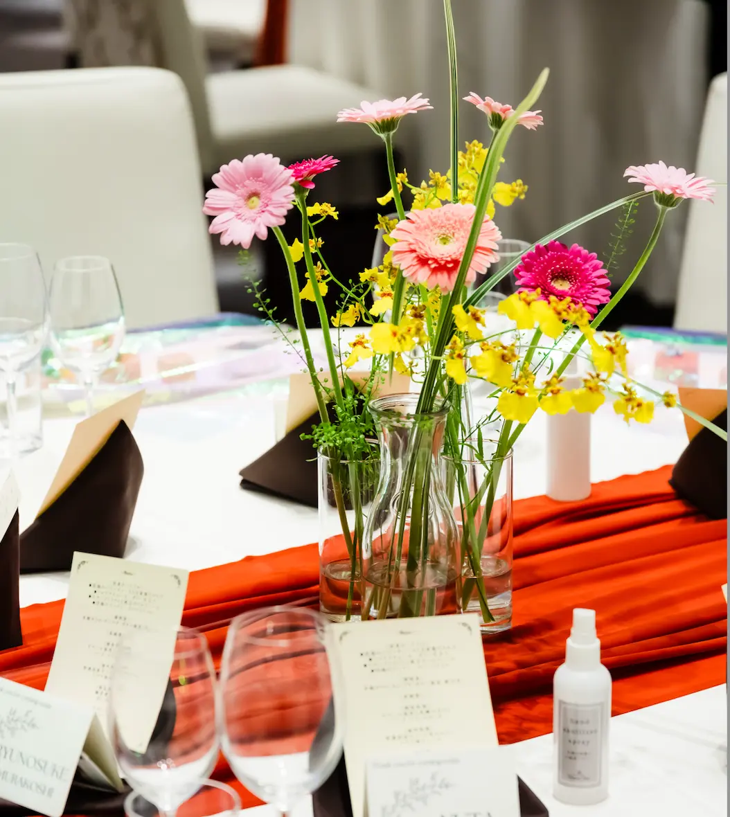カラフルなテーブル装花とお揃いのブーケがおしゃれ！２人で完成させるオリジナルケーキの演出も素敵♪